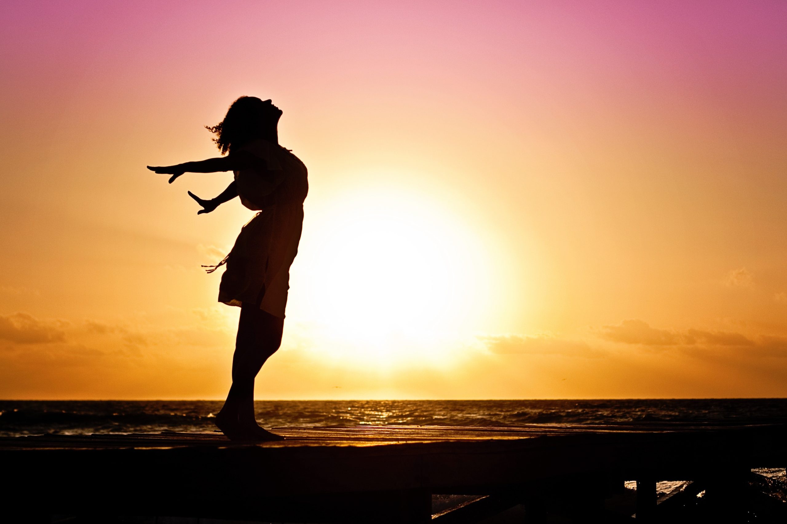 Silhouette of girl in sunset.