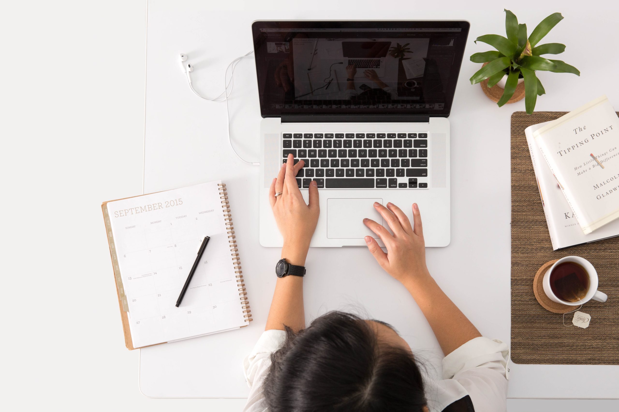 women on laptop with calendar
