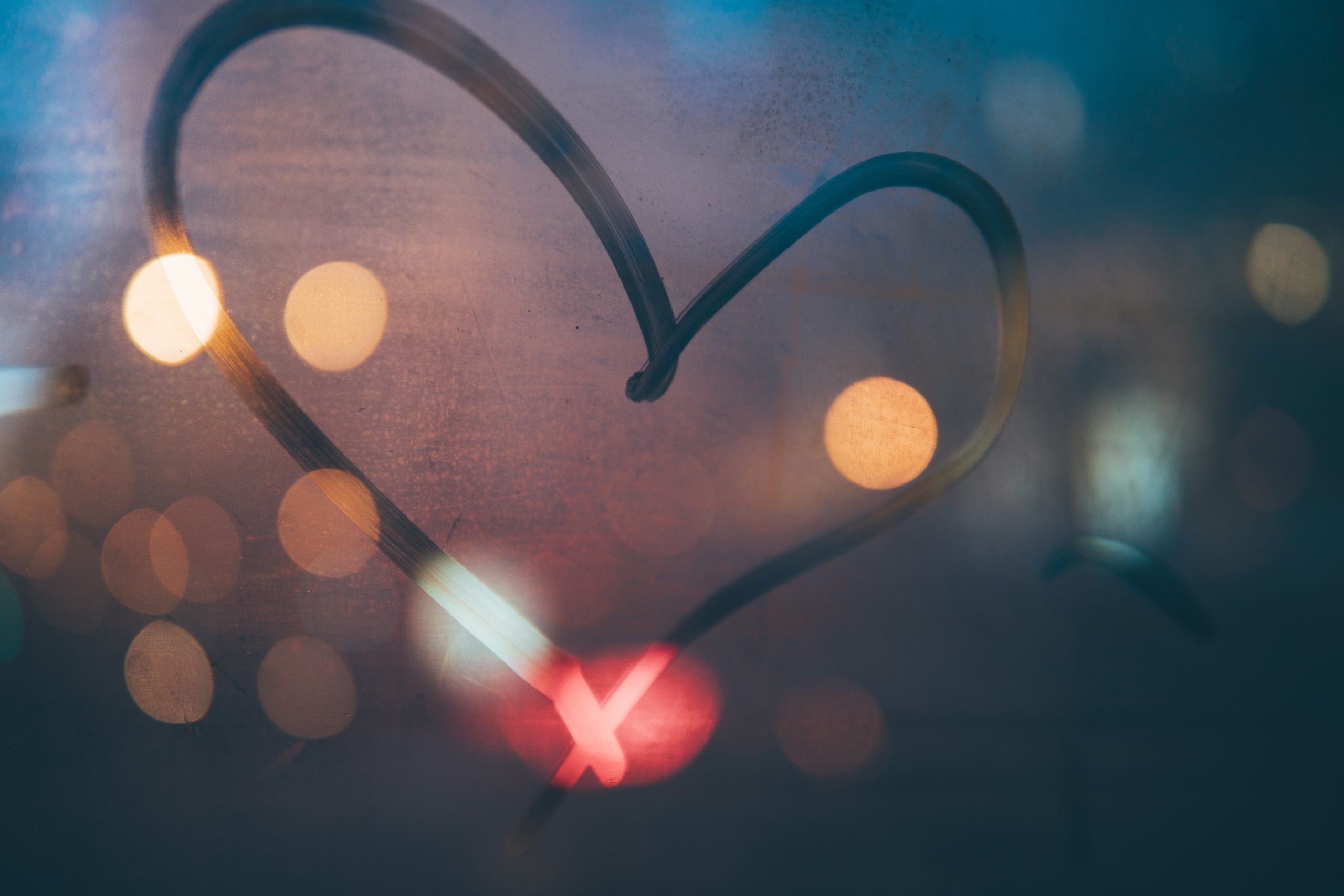 heart drawn on foggy glass