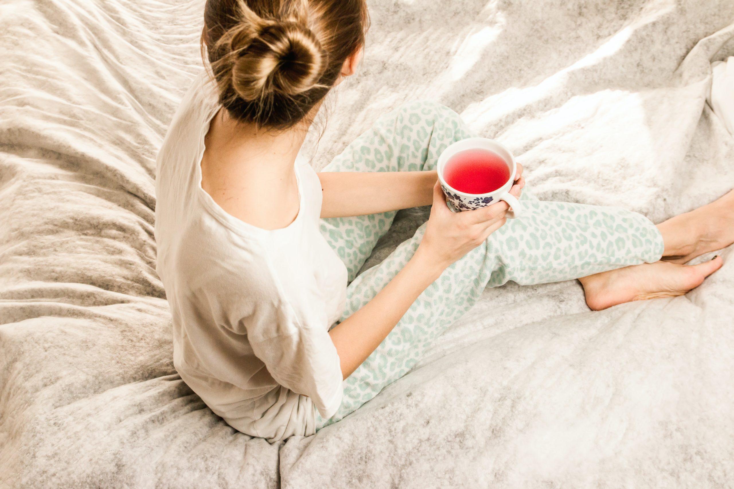 Woman in bed with tea