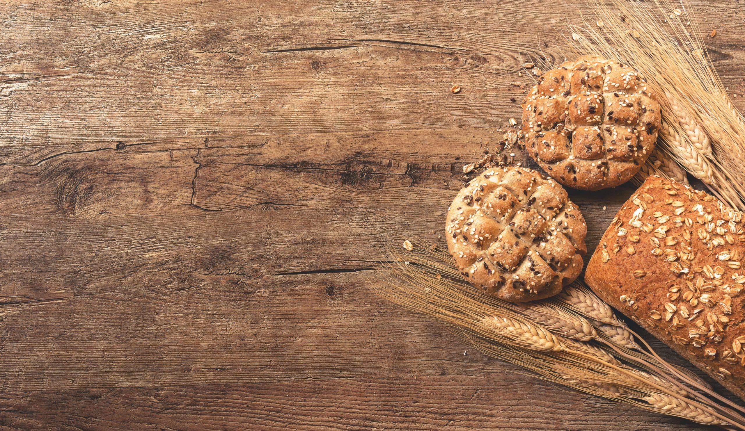 bread and wheat on wood block