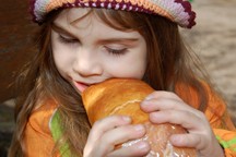 girl eating bread