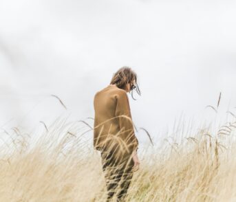 A lonely person in a field.