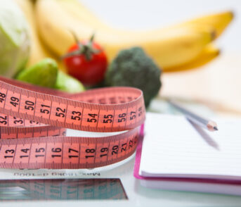 Healthy diet, fitness and weight loss concept, scales, measuring tape, fruits, vegetables on the table.