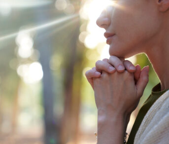 Woman praying and meditating on love and coherence